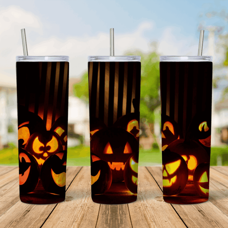 A full 20 oz skinny tumbler wrap with glowing carved jack o lanterns in the dark, lit orange from inside against a black. Sublimation design