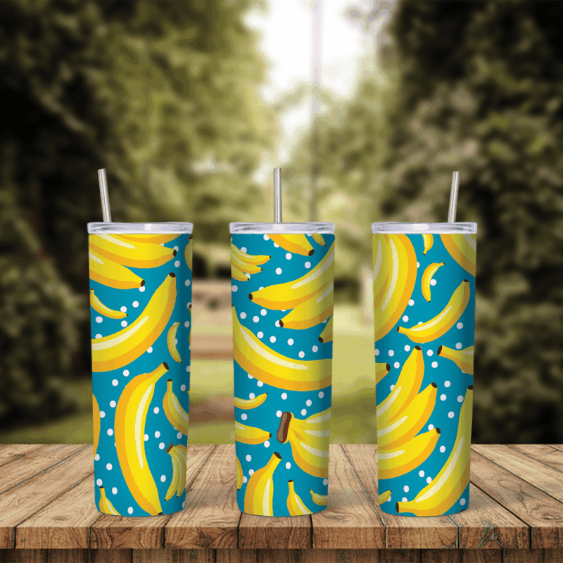 A full 20 oz skinny tumbler wrap with a pattern of yellow bananas and white polka dots on a teal blue background. Sublimation design