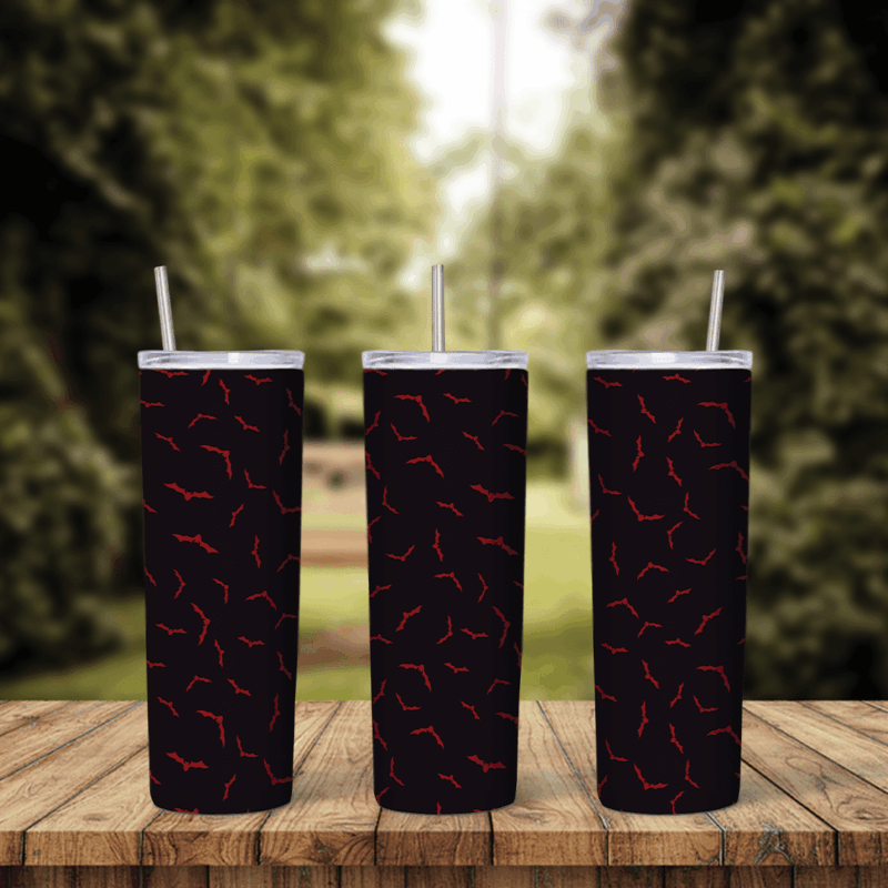 A full 20 oz skinny tumbler wrap with small red bat shapes scattered over a dark black and maroon background. Sublimation design
