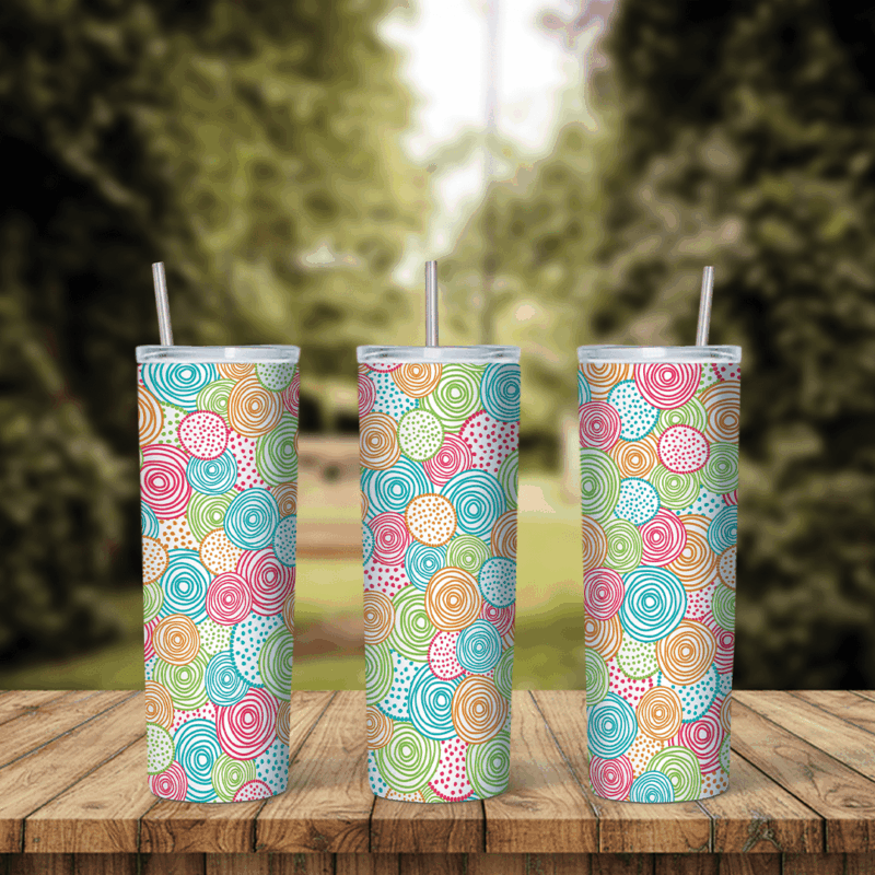 A full 20 oz skinny tumbler wrap with a pastel pattern of swirled circles and dots in pink, mint, blue and yellow. Sublimation design
