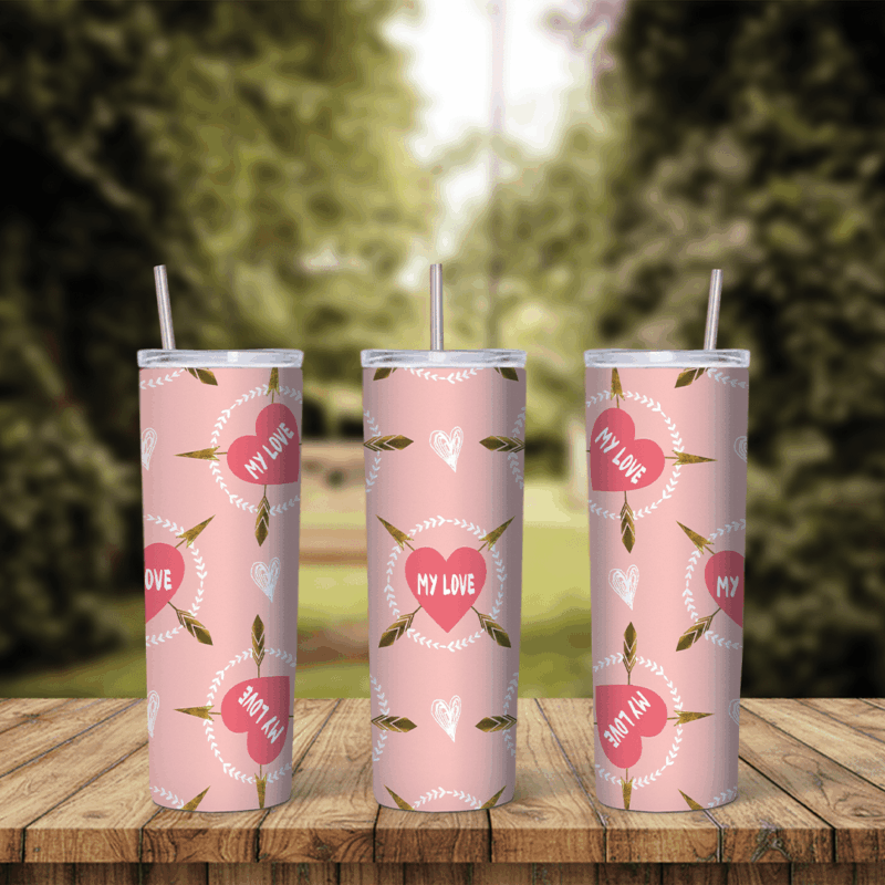 A full 20 oz skinny tumbler wrap in soft pink with red hearts reading My Love and small cupid arrows scattered between them. Sublimation design