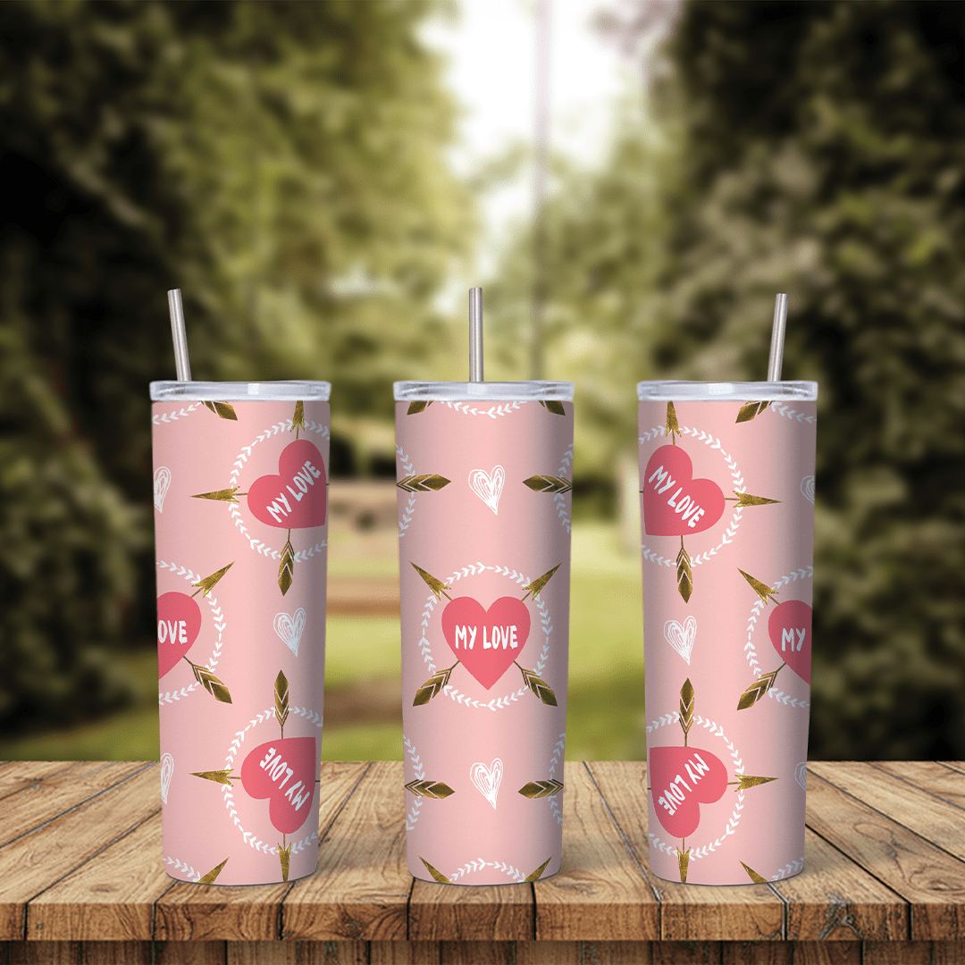 A full 20 oz skinny tumbler wrap in soft pink with red hearts reading My Love and small cupid arrows scattered between them. Sublimation design