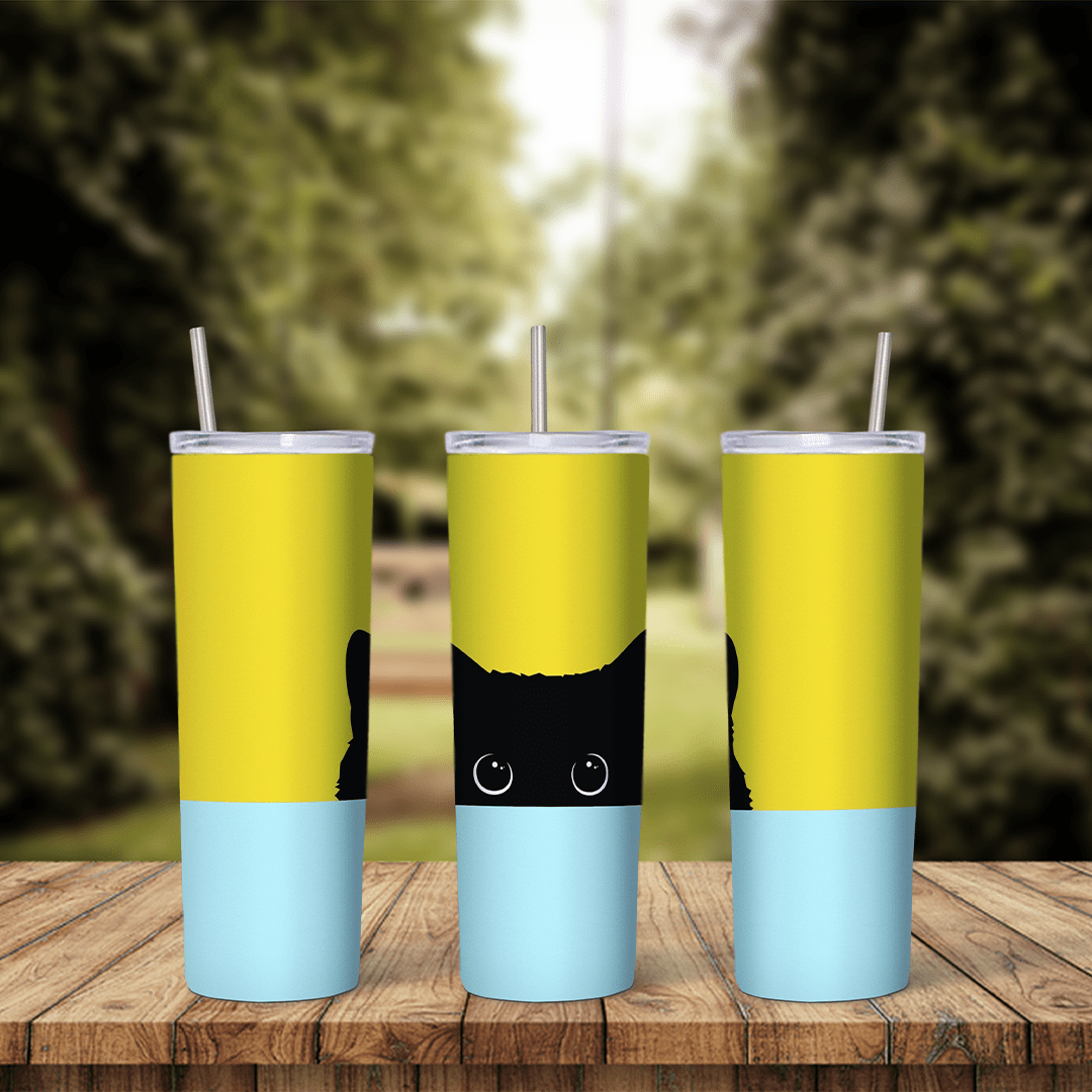 A 20 oz tumbler wrap split into a bright yellow top and pale blue bottom, with a black cat peeking up over the edge in the middle. Sublimation design