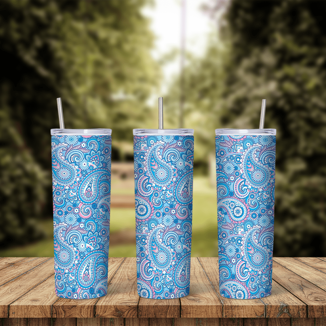 A full 20 oz skinny tumbler wrap with a light blue paisley pattern of teardrop and floral shapes in blue, white and pink. Sublimation design