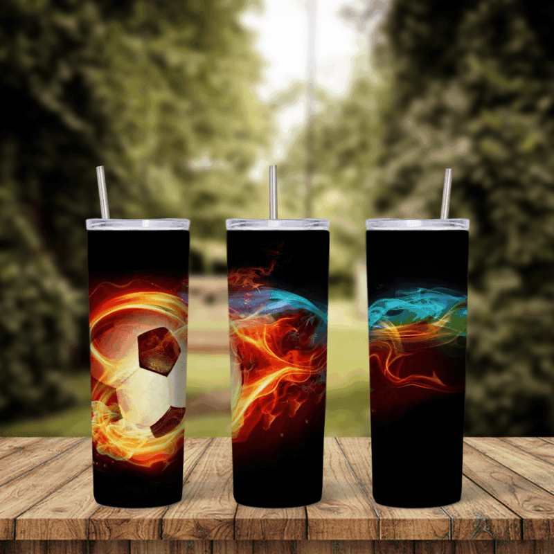 A full 20 oz skinny tumbler wrap with a soccer ball wrapped in orange flames and blue and red fire streaks on a black background. Sublimation design