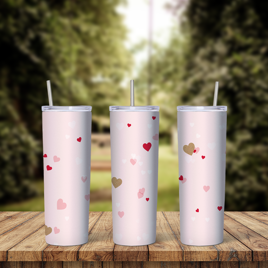 A full 20 oz skinny tumbler wrap on pale pink with small scattered hearts in red, pink and gold. Sublimation design