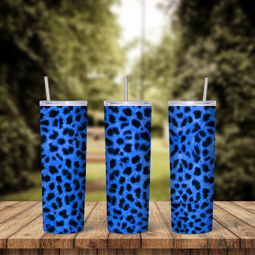 A leopard print tumbler wrap in bright royal blue with black leopard spots covering the whole cup from top to bottom in an all. Sublimation design