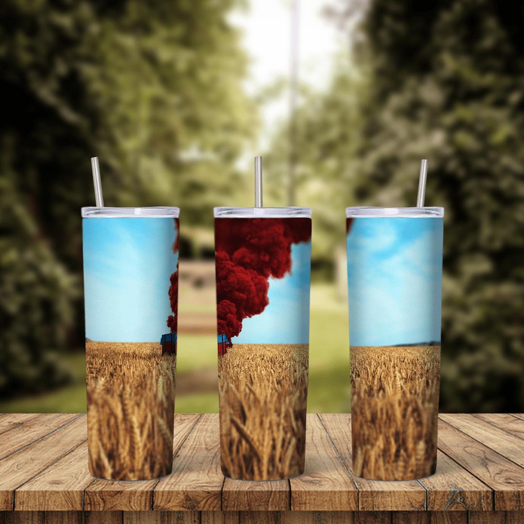 A full 20 oz skinny tumbler wrap with PUBG game art: a column of red smoke rising over a golden wheat field under a light blue sky. Sublimation design