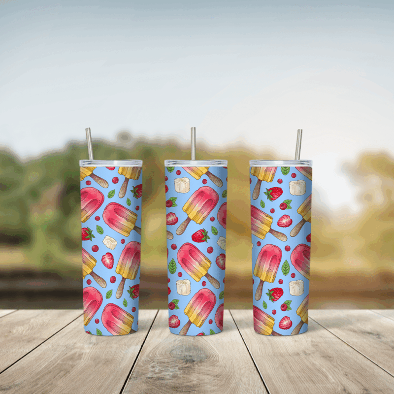 A full 20 oz skinny tumbler wrap with a pattern of pink and yellow popsicles, strawberries and fruit pieces on a light blue. Sublimation design