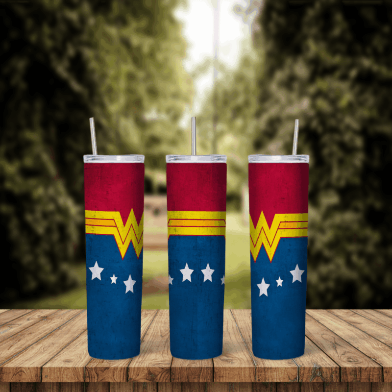 A Wonder Woman tumbler wrap in dark blue with a row of white stars, a red top band and the gold W emblem repeated around the cup. Sublimation design