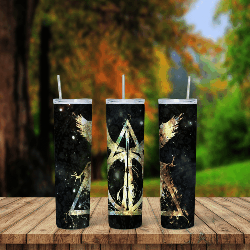 A 20 oz skinny tumbler wrap with a gold Deathly Hallows symbol and gold phoenix wings on a black starry background. Sublimation design