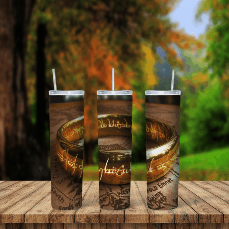 A Lord of the Rings tumbler wrap showing a close up of the golden One Ring with its glowing inscription resting on an old. Sublimation design