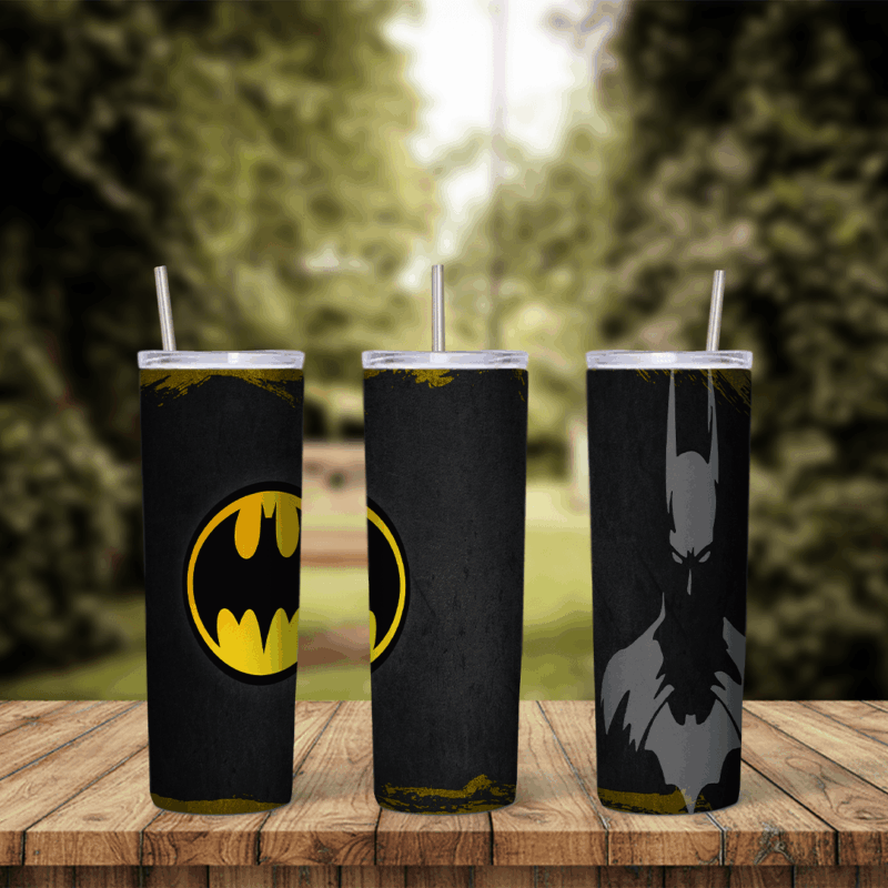 A 20 oz skinny tumbler wrap on a black grunge background with gold worn edges: the yellow Batman bat logo on one side and a gray. Sublimation design