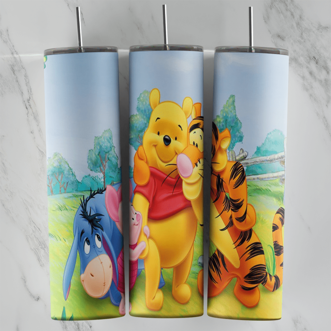 A 20 oz skinny tumbler wrap with Eeyore, Piglet, Pooh and Tigger hugging in a green meadow with trees, a wooden fence and a pale. Sublimation design