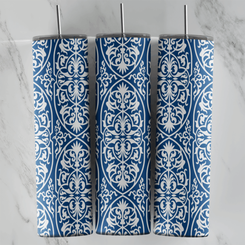 A 20 oz skinny tumbler wrap with a blue and white arabesque pattern: white filigree medallions and scrollwork in vertical rows. Sublimation design