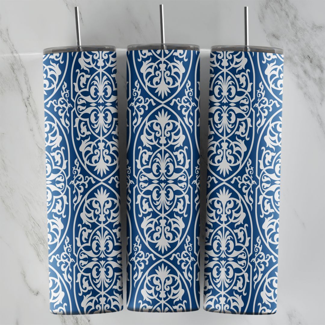 A 20 oz skinny tumbler wrap with a blue and white arabesque pattern: white filigree medallions and scrollwork in vertical rows. Sublimation design