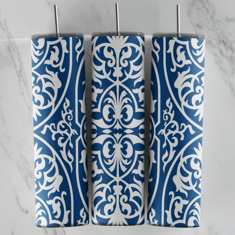 A 20 oz skinny tumbler wrap with a blue and white arabesque pattern: white filigree medallions and scrolls on cobalt blue. Sublimation design