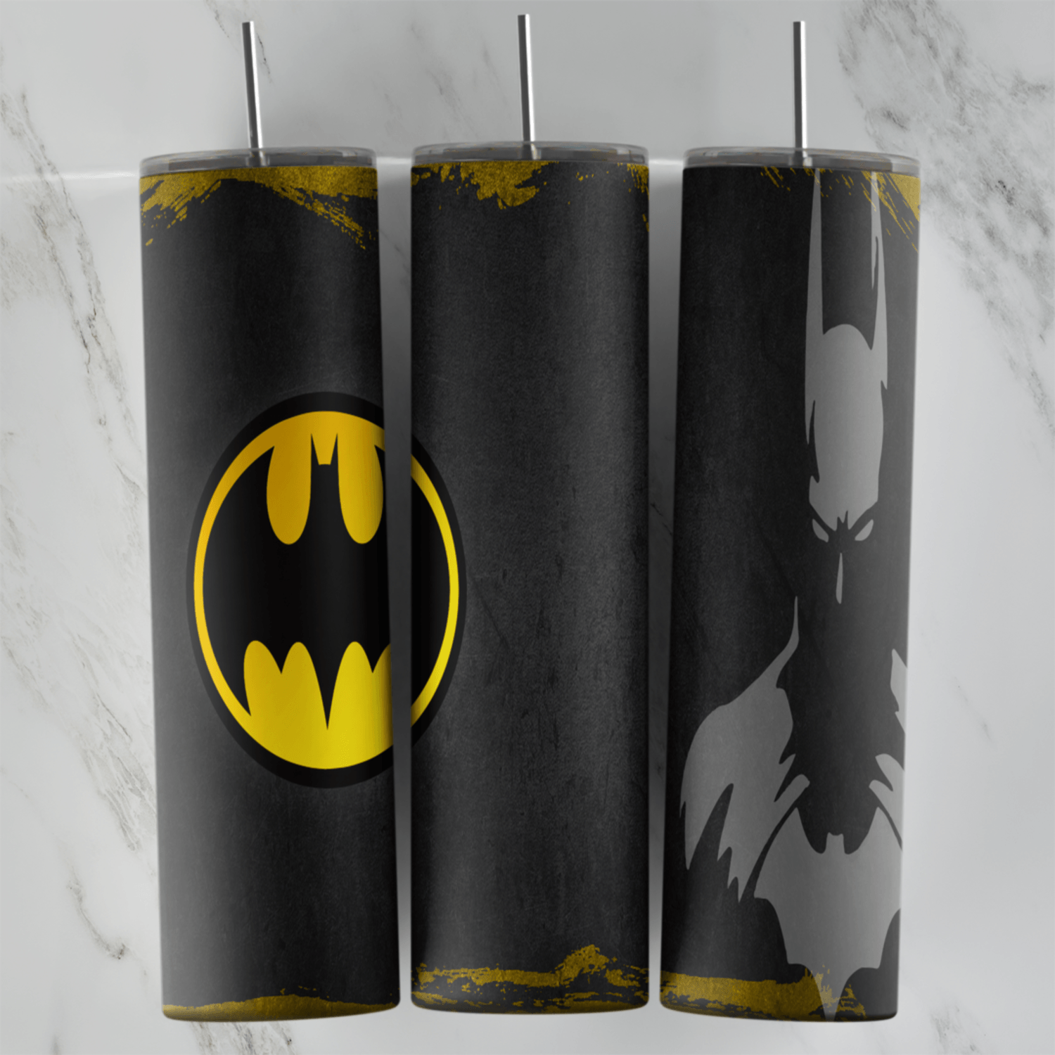 A dark 20 oz tumbler wrap with a yellow bat signal style logo on one side, a faded gray Batman silhouette on the other and worn. Sublimation design