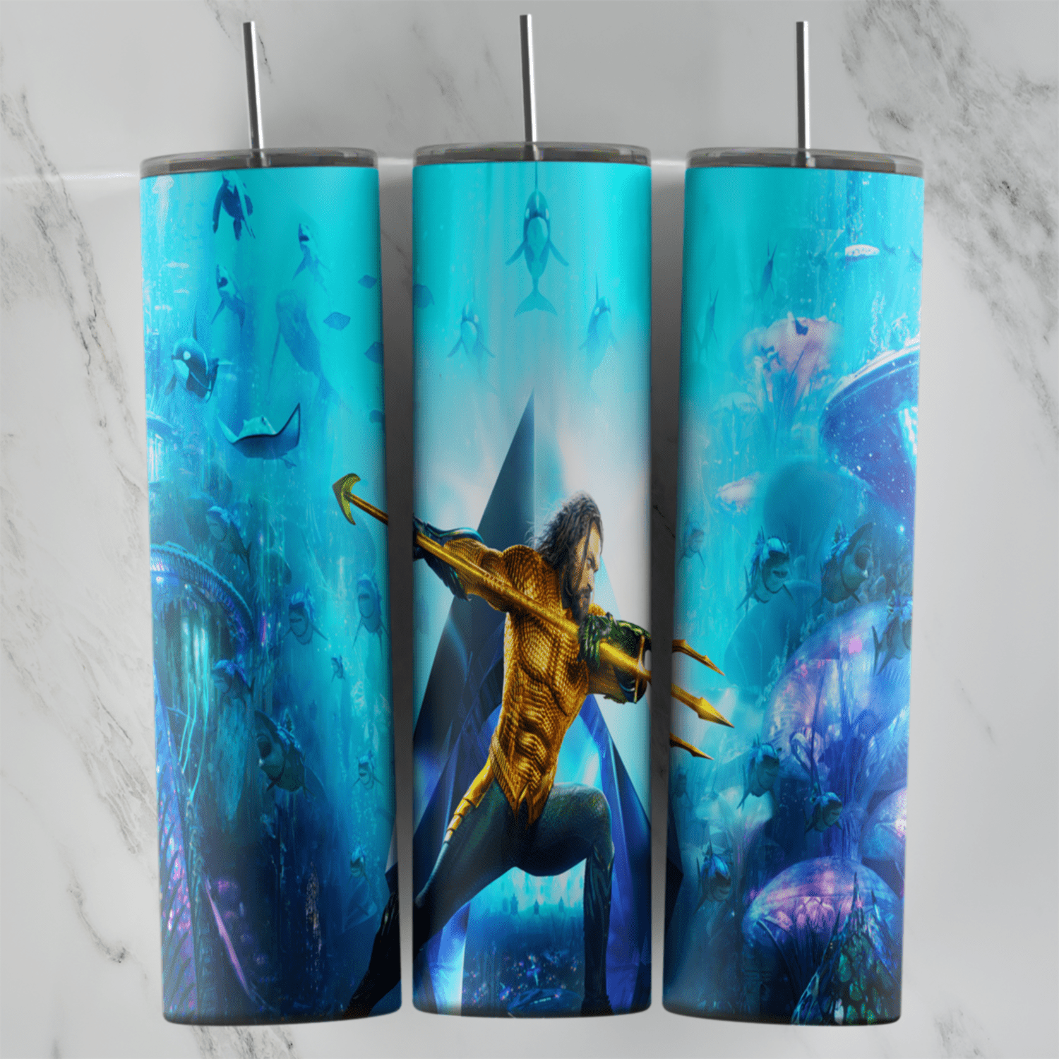 A full 20 oz skinny tumbler wrap of Aquaman in his gold suit thrusting a trident, set in a blue underwater scene with fish. Sublimation design