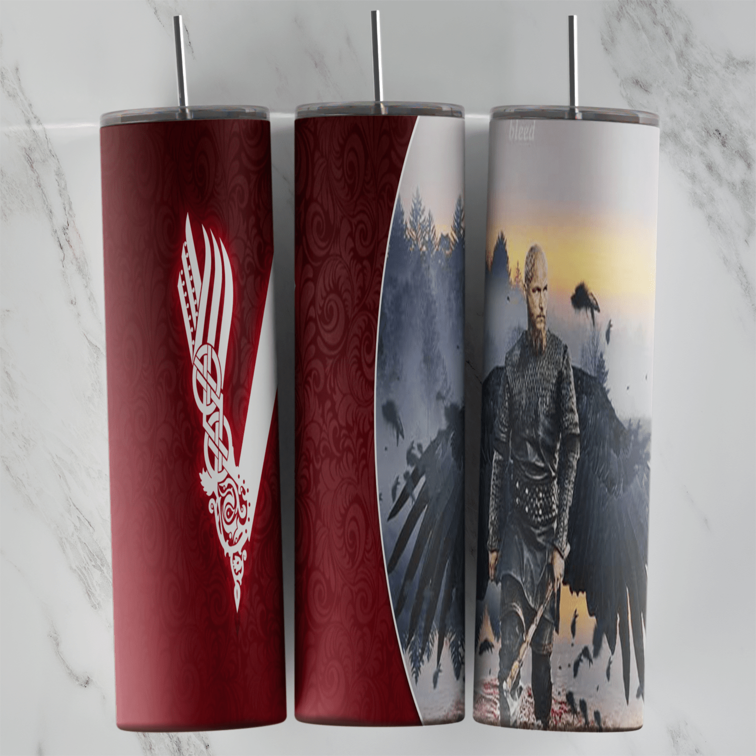 A 20 oz skinny tumbler wrap with the white Vikings V logo on dark red and a lone warrior framed by spread black raven wings under. Sublimation design