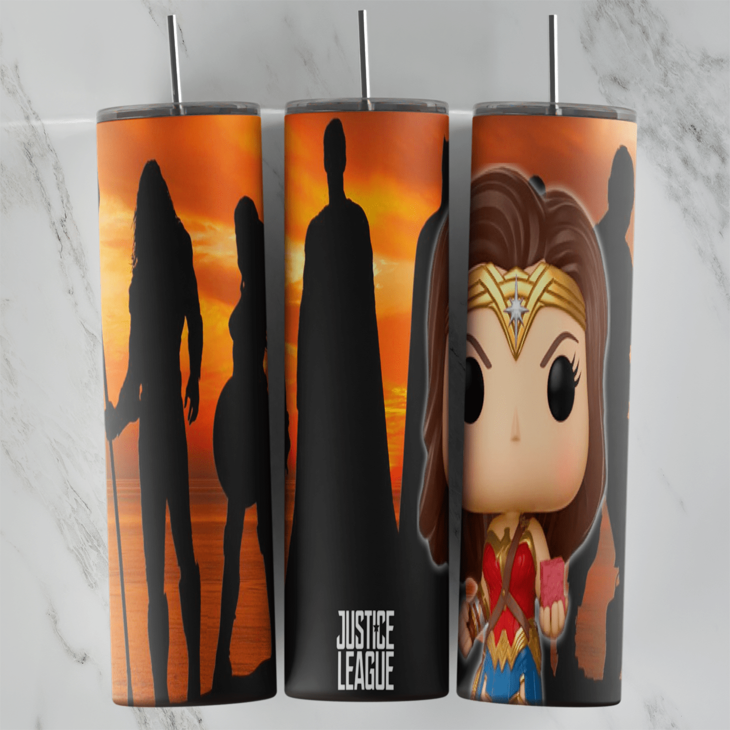 A Wonder Woman tumbler wrap with hero silhouettes against an orange sunset, Justice League lettering and a big-headed collectible. Sublimation design