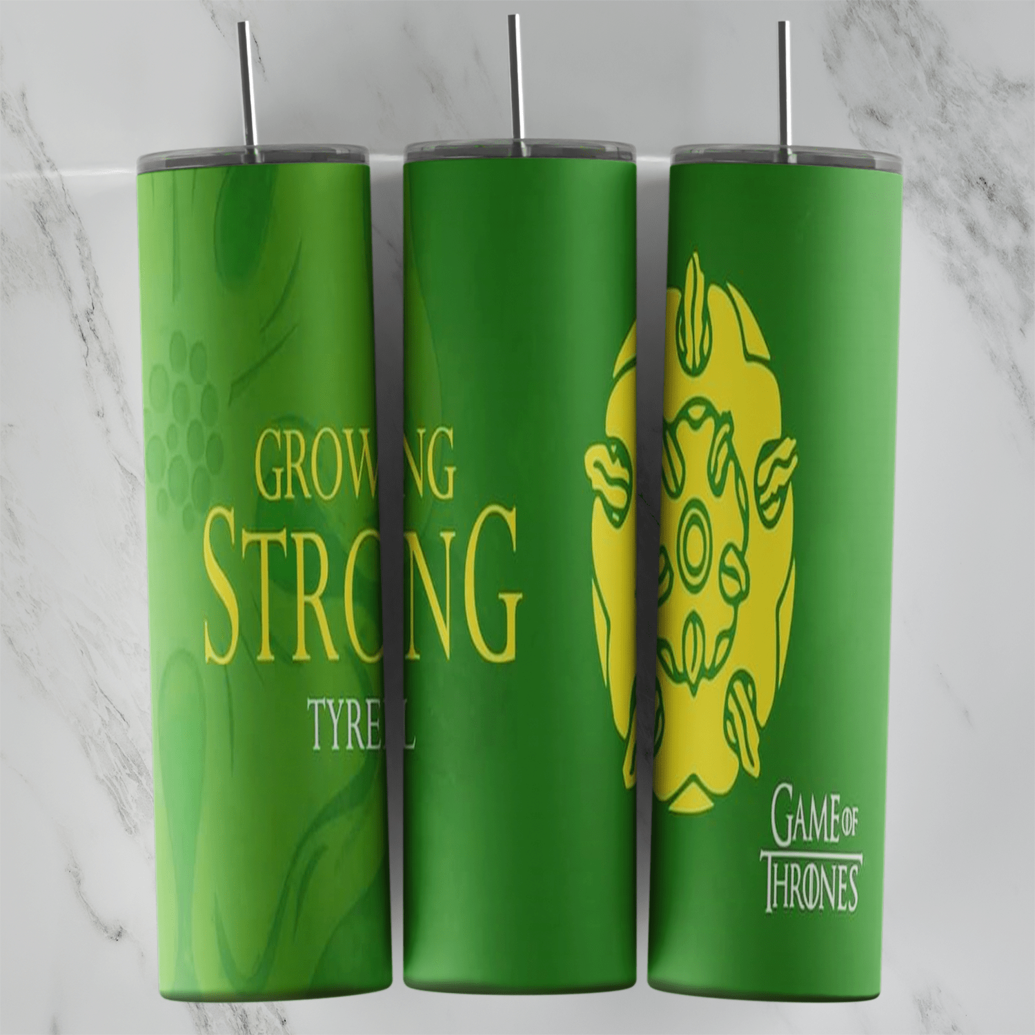 A 20 oz skinny tumbler wrap in green for House Tyrell: Growing Strong lettering in yellow, a golden rose sigil and a small Game. Sublimation design