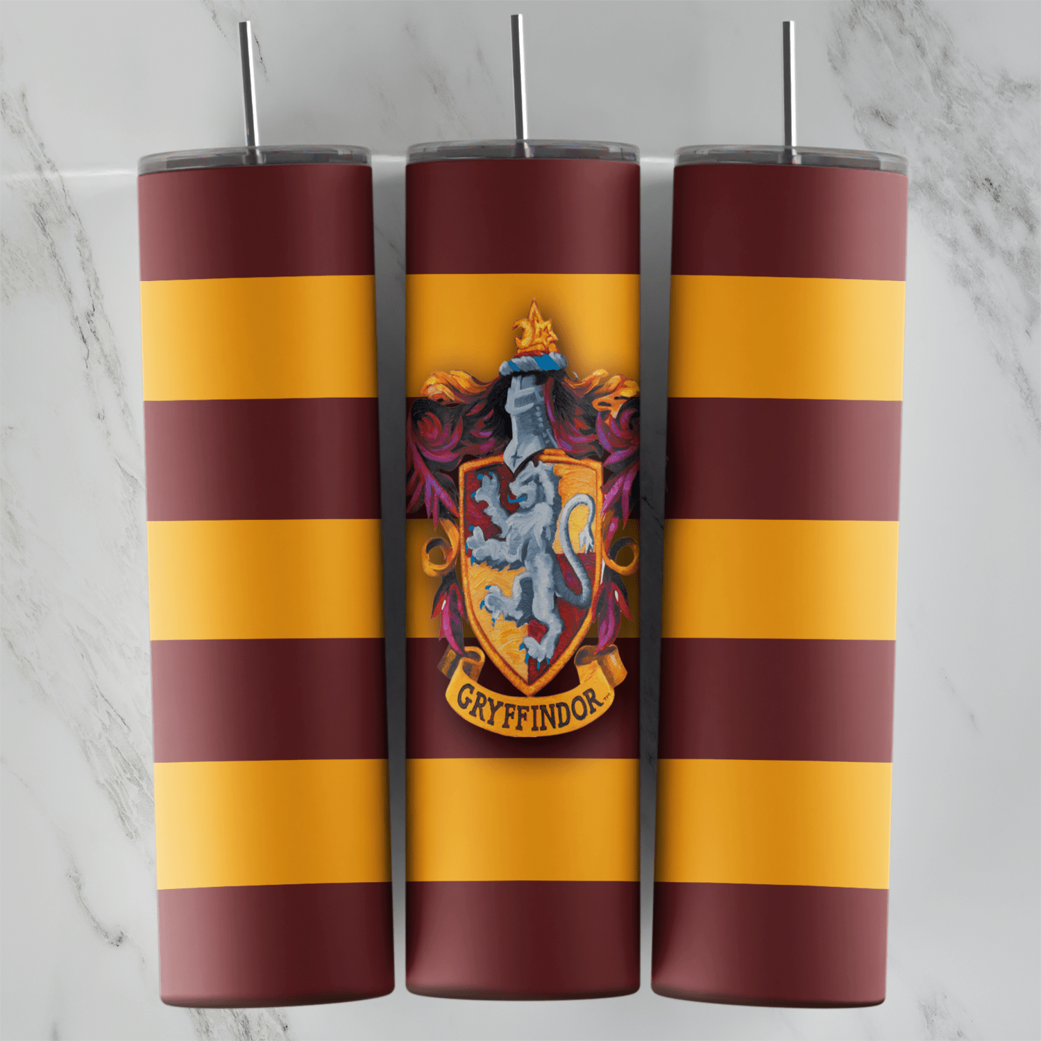 A 20 oz skinny tumbler wrap with maroon and gold horizontal stripes and the Gryffindor lion crest in the center. Sublimation design