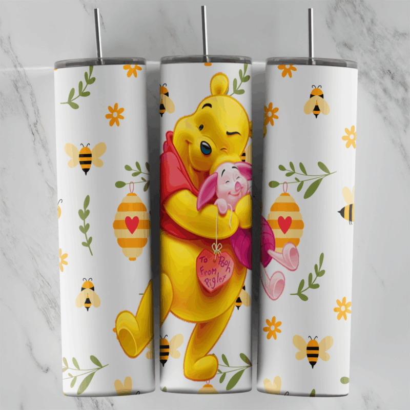 A 20 oz skinny tumbler wrap with Pooh hugging Piglet and a pink heart, surrounded by bumblebees, striped beehives, yellow flowers. Sublimation design