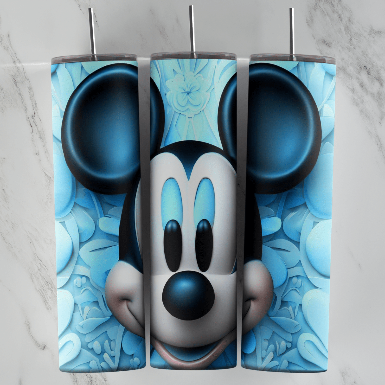 A 20 oz skinny tumbler wrap with a pale 3D Mickey Mouse face and dark blue ears on a light blue embossed floral background. Sublimation design