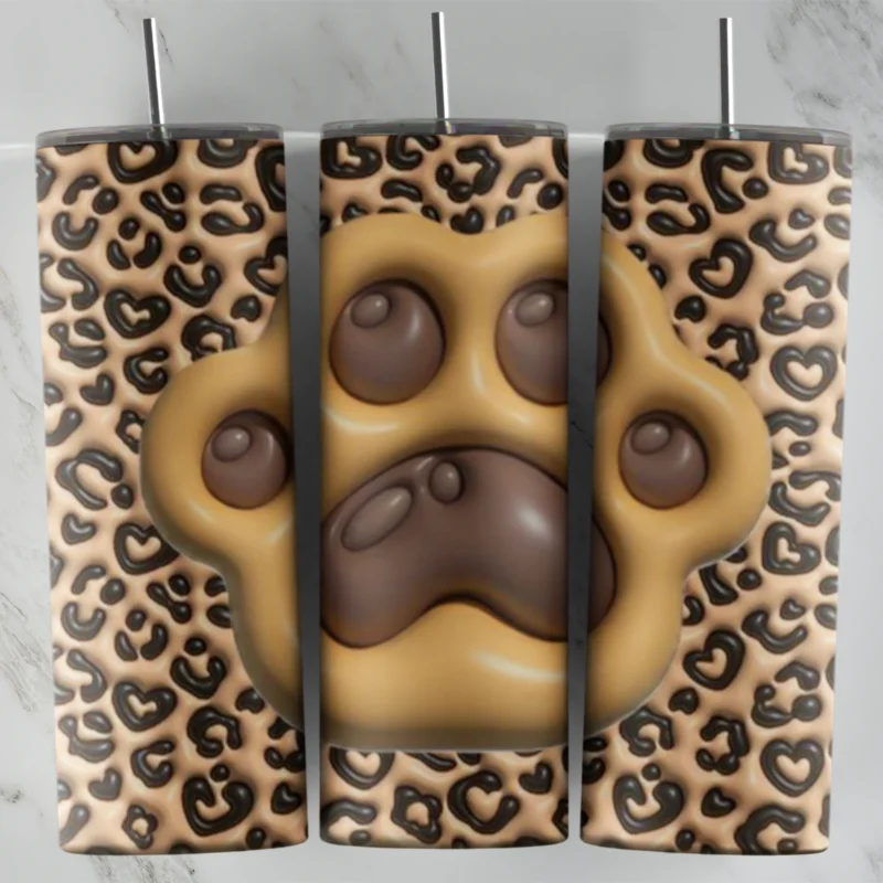 A full 20 oz skinny tumbler wrap in puffy 3D inflated style: a large tan paw print with brown pads over a classic tan and brown. Sublimation design
