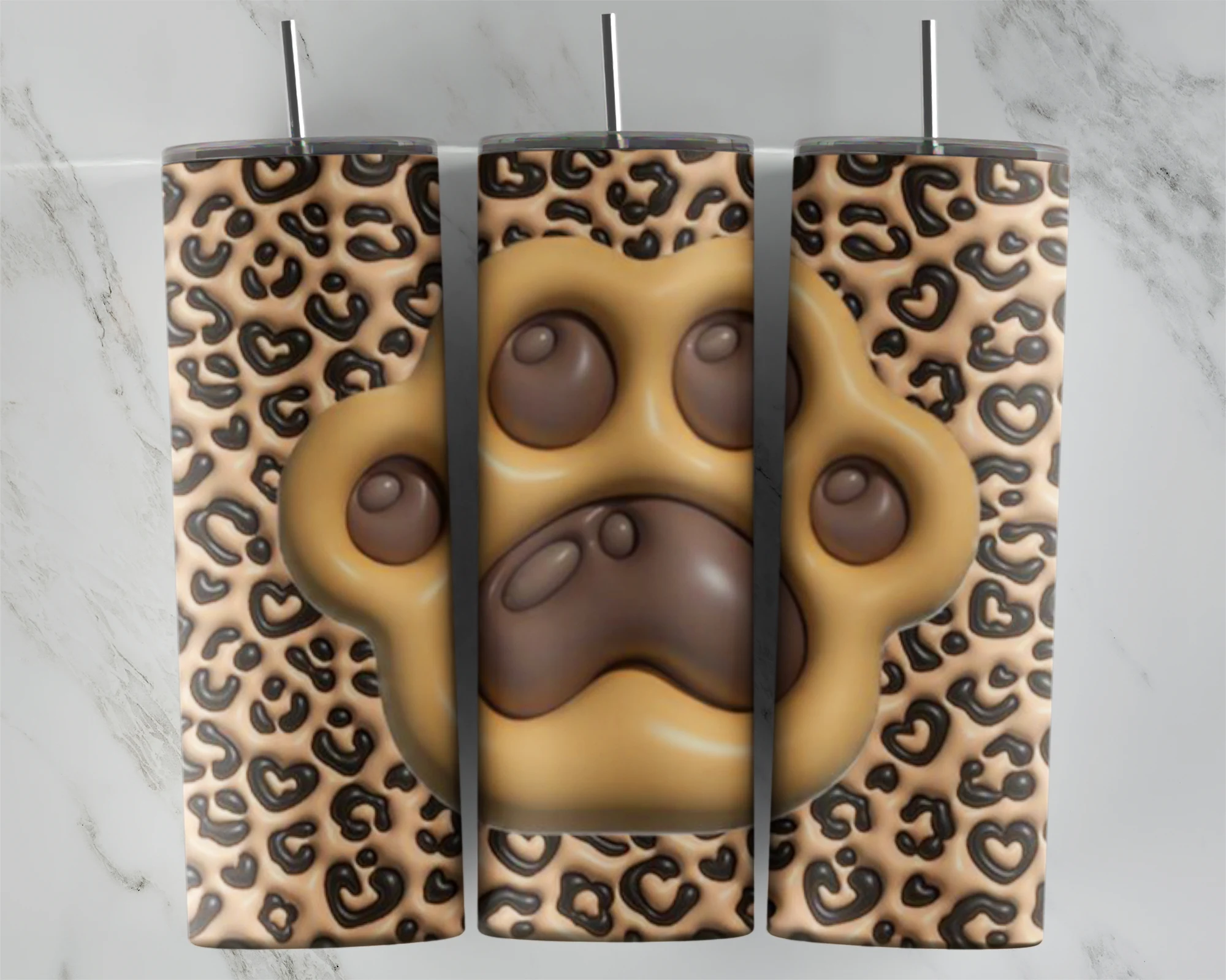 A full 20 oz skinny tumbler wrap in puffy 3D inflated style: a large tan paw print with brown pads over a classic tan and brown. Sublimation design
